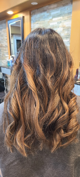 Caramel balayage on mid-back-length wavy brown hair at GMS Beauty Salon in Madera, CA