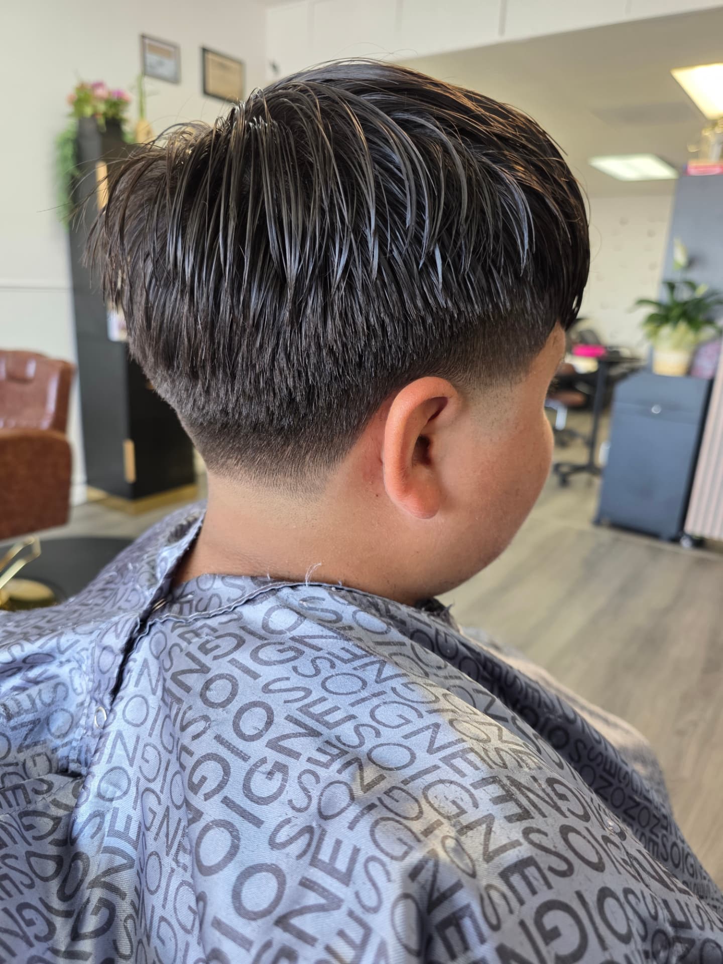 Short men's haircut with a low fade, viewed from behind at GMS Beauty Salon
