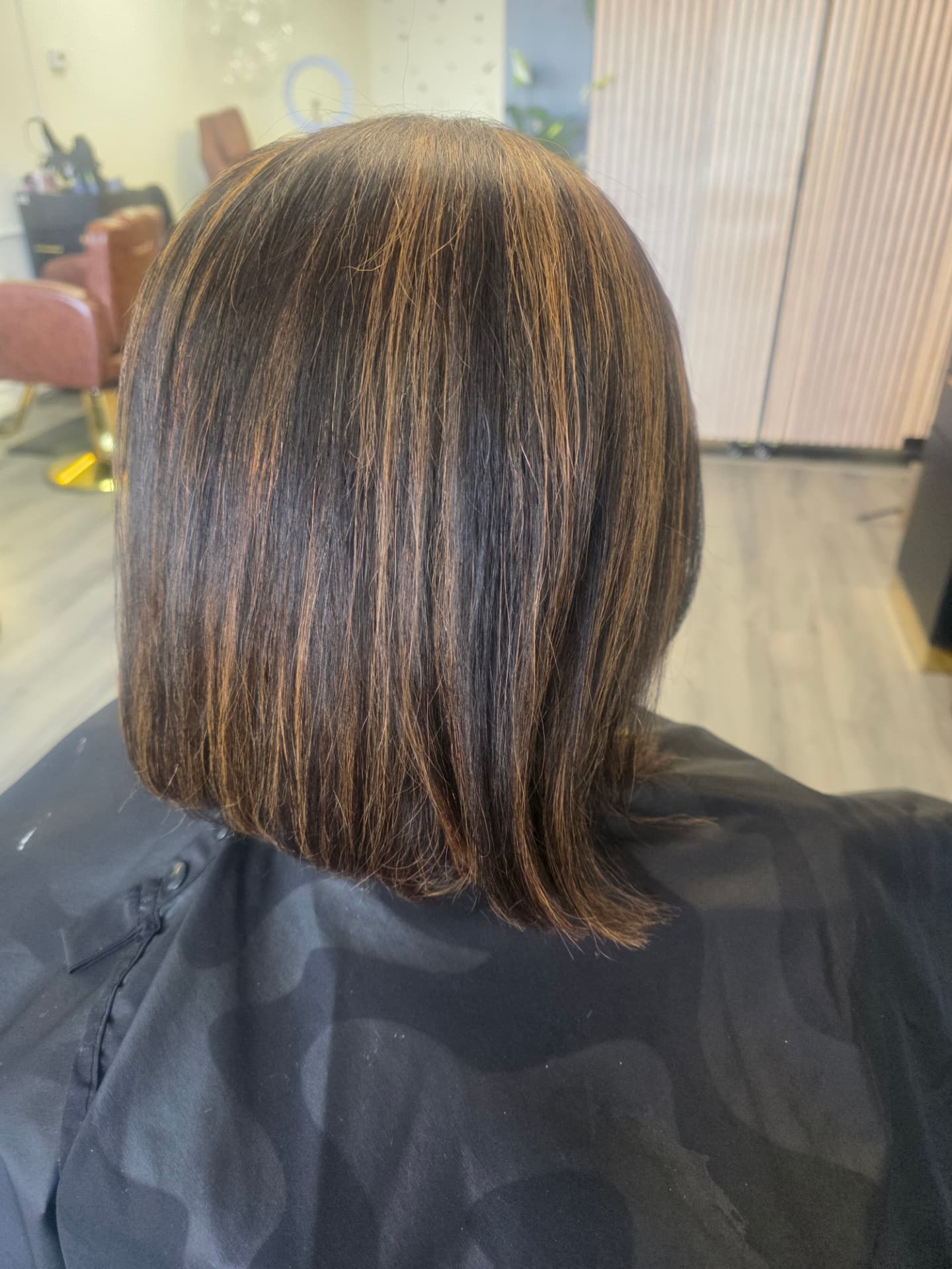 Women's bob haircut with caramel highlights at GMS Beauty Salon