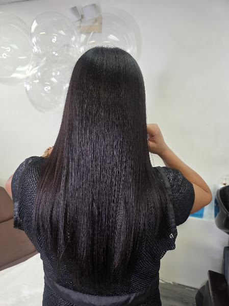 After keratin treatment: long, smooth and shiny hair viewed from behind at GMS Beauty Salon in Madera, CA