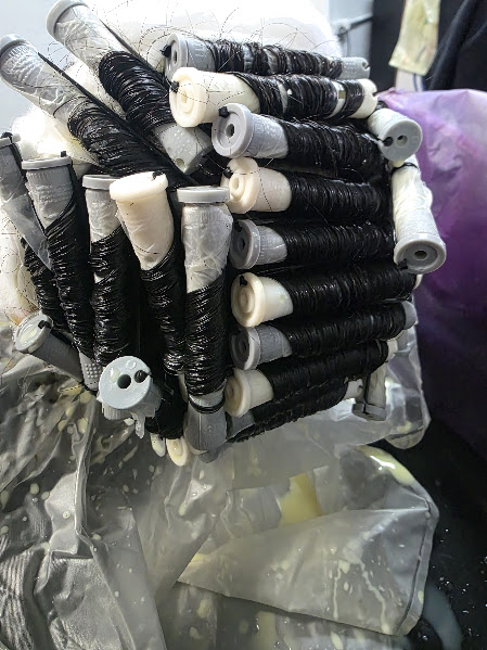 Before the second men's perm result: dark hair wrapped around black and white rods