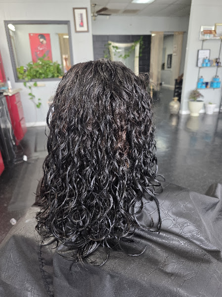 After a women's perm: long dark hair with defined waves and movement